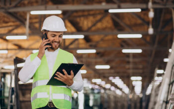 young-man-engineer-working-factory-making-order-phone